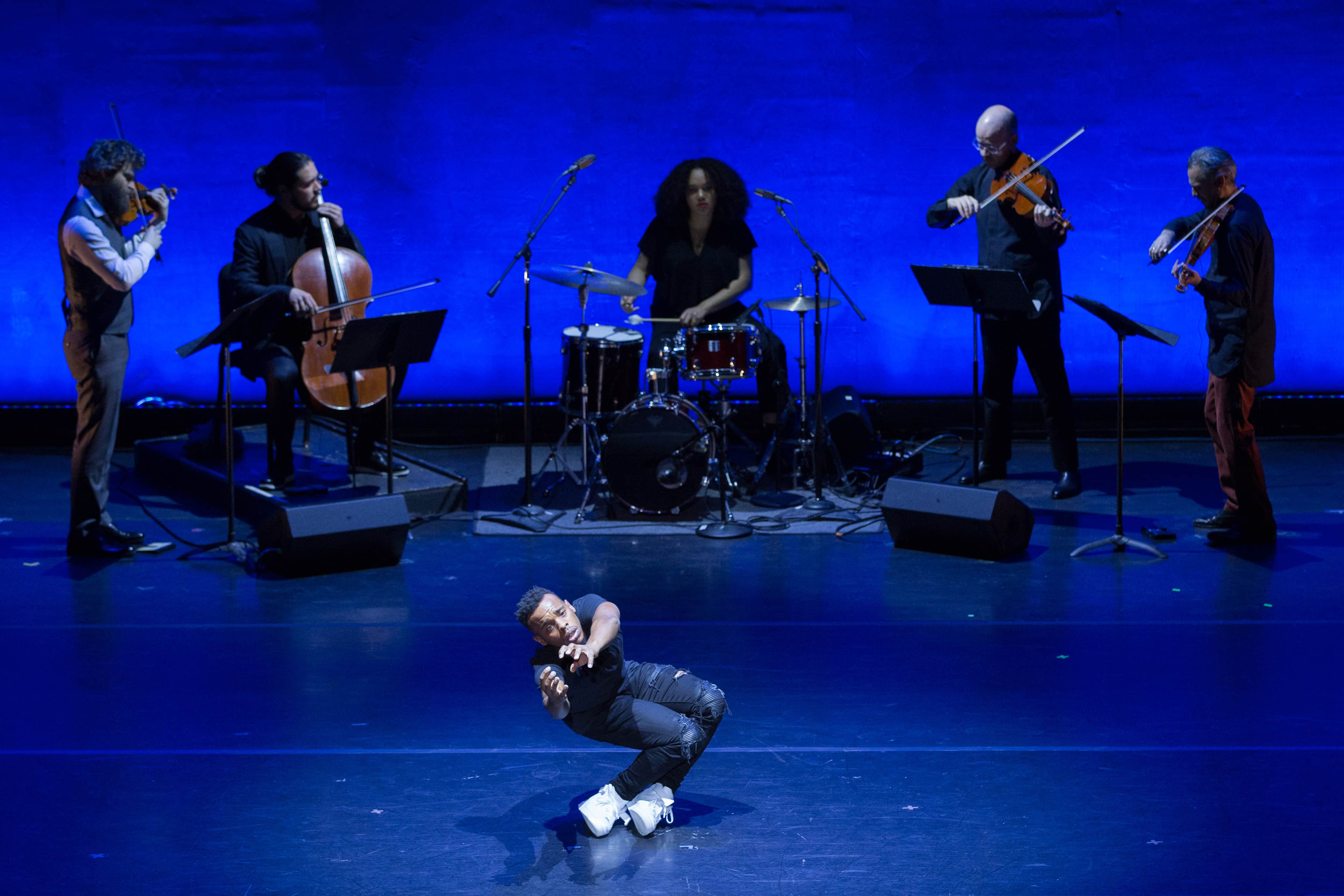 Charles "Lil Buck" Riley performs, backed by Brooklyn Rider and Savannah Harris, in DEMO by Damian Woetzel: Now. Photo by Teresa Wood.
