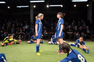 Chrissy Rose, Katie Kleiger and the cast of The Wolves. Photo by Teresa Wood.