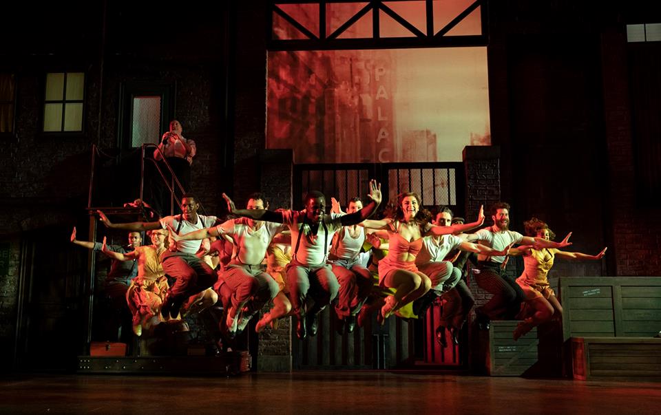 James T. Lane (center) and company. Photo by Joan Marcus. 