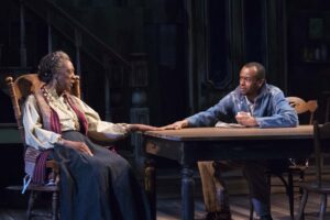 Spiritual healer and young man in need of soul washing: Stephanie Berry (Aunt Ester) and Justin Weaks (Citizen Barlow) in ‘Gem of the Ocean.’ Photo by Kaley Etzkorn.