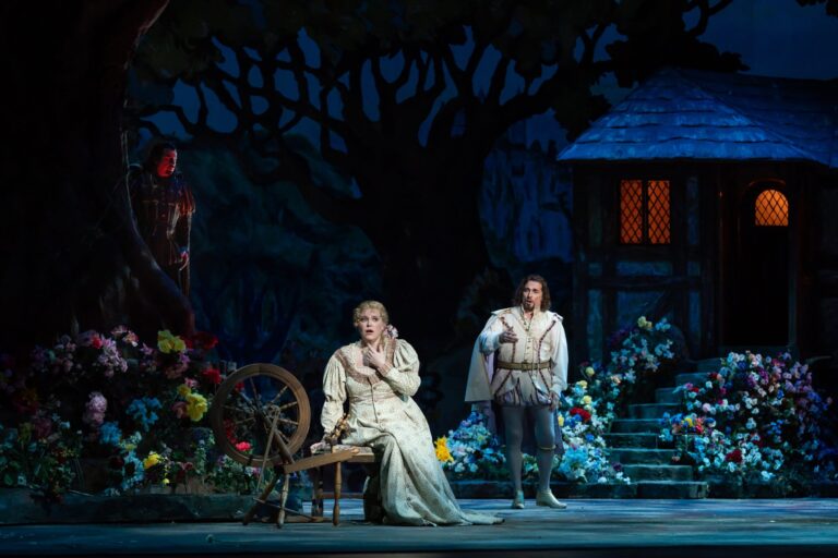 The devil (Raymond Aceto) looks on as Faust (Marcelo Puente) woos Marguerite (Erin Wall) in WNO's production of 'Faust.' Photo by Scott Suchman.