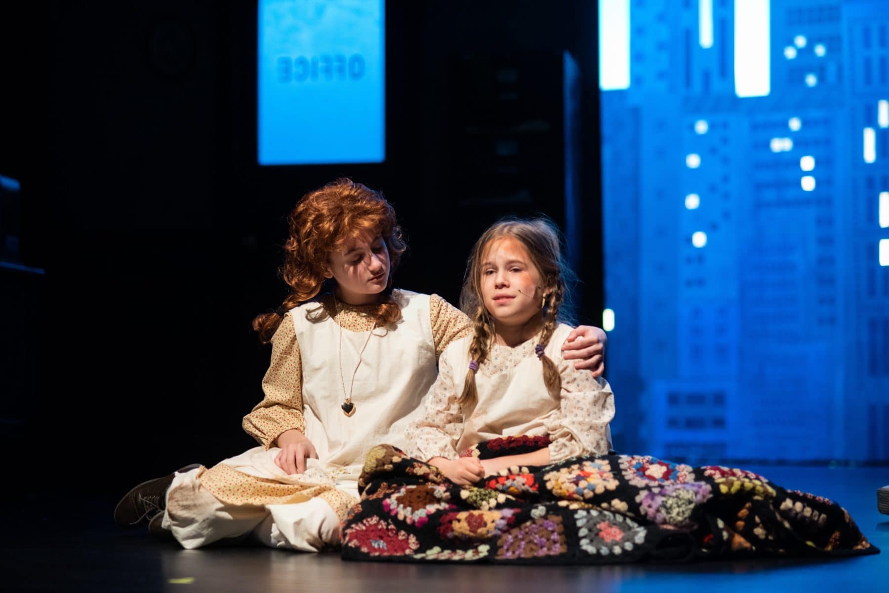 Kylee Hope Geraci (Annie) comforts Jane Keifer (Molly) in Reston Community Players' 'Annie.' Photo by Jennifer Heffner Photography.