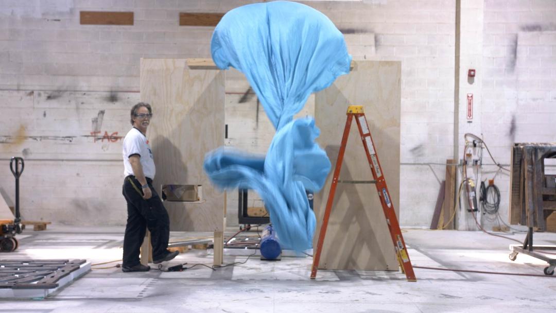 Michael Young experiments with the properties of fabric. Photo courtesy of Shakespeare Theatre Company. 